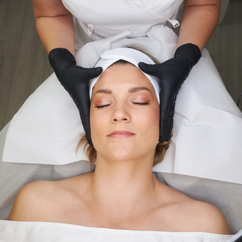 Person receiving a relaxing facial massage at a spa.